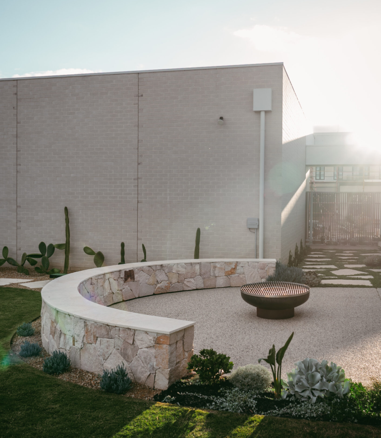 Natural stone wall and fire pit by Sylvita Landscaping