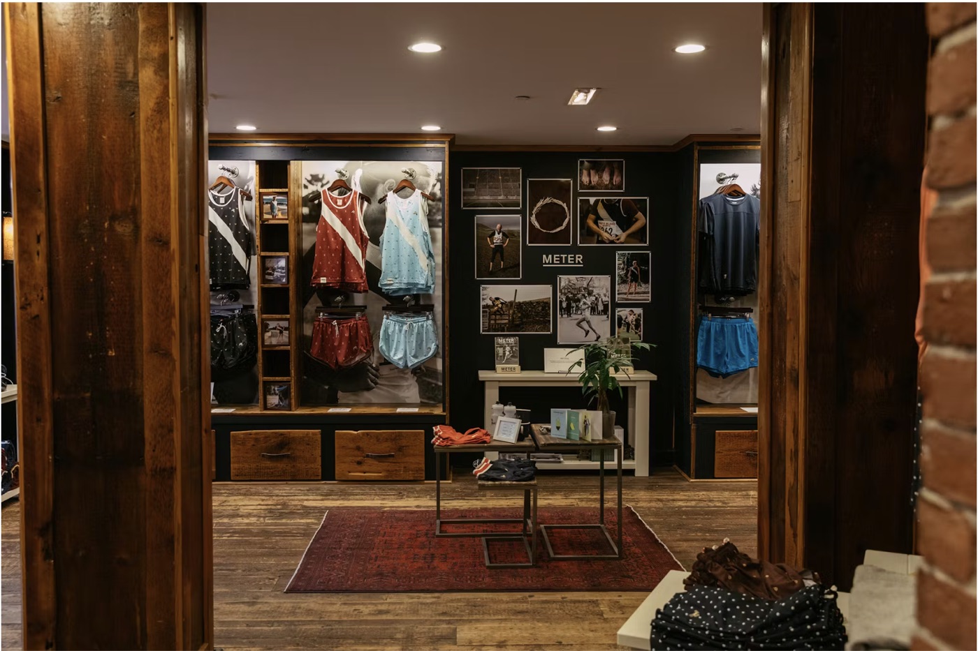 A wood-paneled running store with singlets on wooden hangers