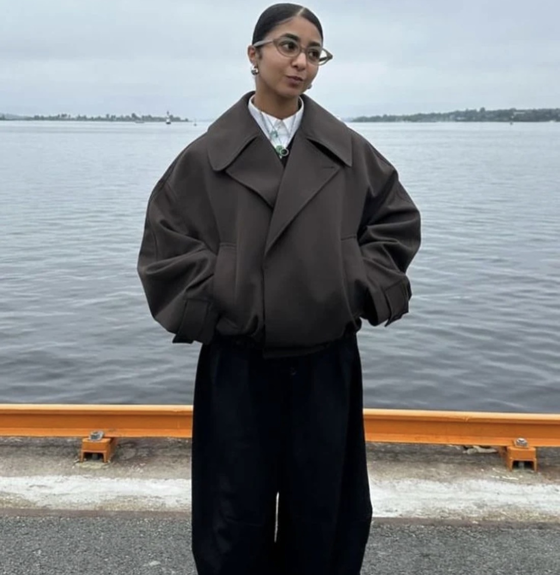 Boxy oversized brown jacket by the water