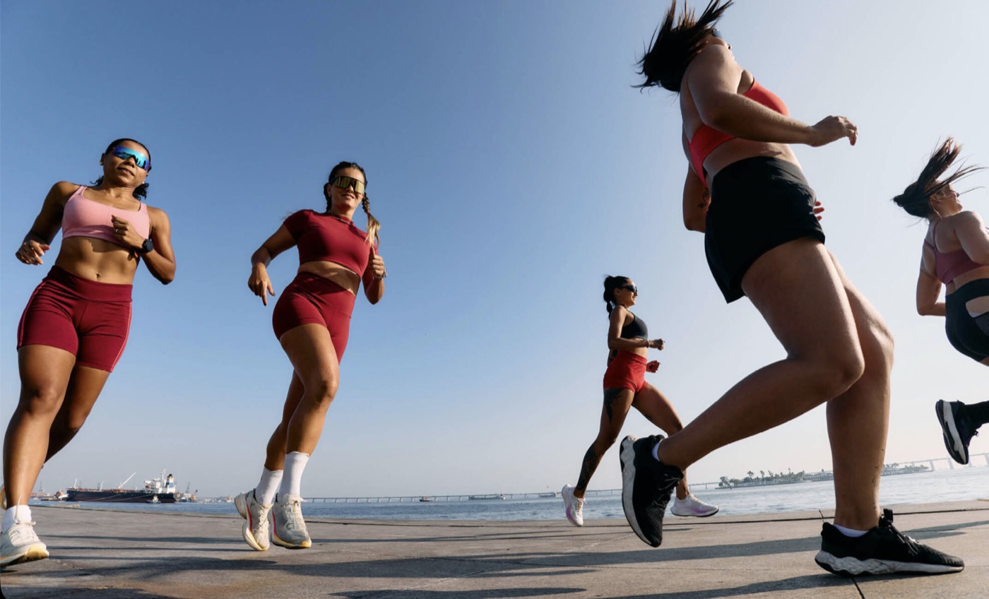 A group of women running together along the waterfront